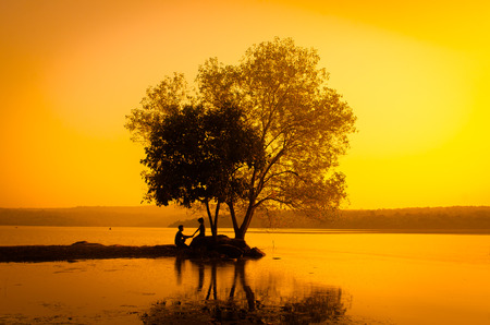 silhouette couple at the lake sideの写真素材