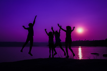 silhouette family jumping, sunset holidayの写真素材