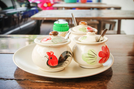 Ceramic Condiment Containers on wood tableの写真素材