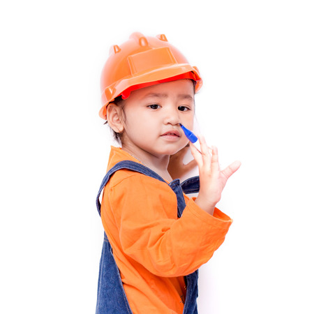 Asian Engineer baby girl with pen in hand on white backgroundの写真素材