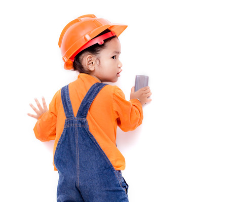 Asian Engineer baby girl with eraser brush in hand on white backgroundの写真素材