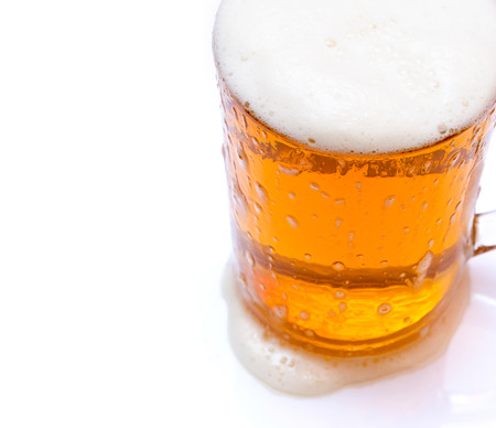 Isolated beer in glass mug on white backgroundの写真素材
