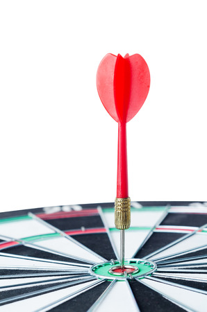 Close up shot red dart arrow on center of dartboard, metaphor to target success, winner concept, Isolated on white background with clipping pathの写真素材