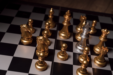 Close up shot chess on the board game with dark mood and tone process competition conceptの写真素材