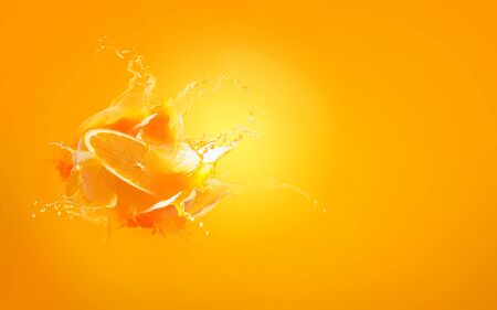 Slide cut piece of orange drop on orange background with orange juice splash water with copy spaceの写真素材