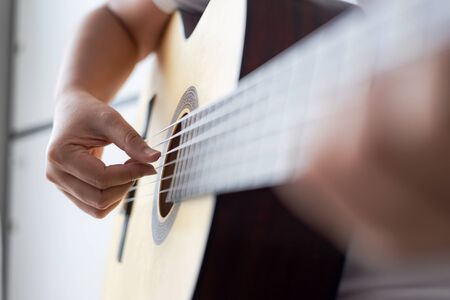 Woman hands playing acoustic classic guitar the musician of jazz and easy listening style select...