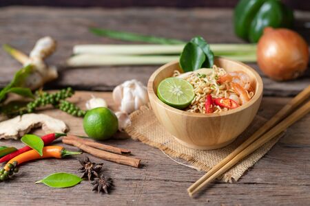 Close-up shot Instant noodles with lemon shrimp chilli hot and spicy on old wooden table select focus shallow depth of fieldの写真素材