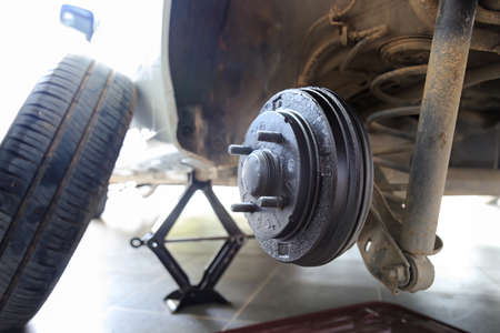 A rear hub of the car after removing a tire and wheel, maintaining a brake and wheel system, car jack-up for change a car wheel, Close-up shotの写真素材