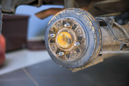 A rear hub of the car after removing a tire and wheel, maintaining a brake and wheel system, car jack-up for change a car wheel, Close-up shotの写真素材