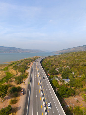 The M6  motorway Expressway Nakhon Ratchasima Province - Bang Pa-in. Lam Ta Khong River and Mountain. Drone shot of scenic landscape rural place traffic. Nakhon Ratchasima Thailand. Motorway Koratの写真素材