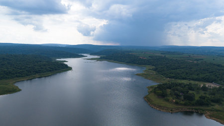 Drone shot. Aerial view scenic landscape of a large river delta amid a lush forest at the tropical Asia placeの写真素材
