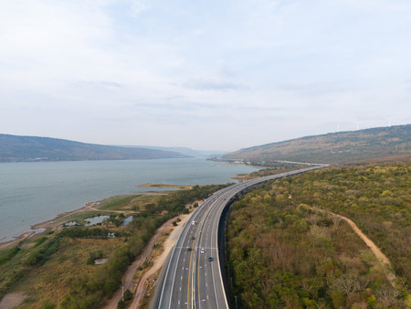 The motorway Expressway Nakhon Ratchasima Province - Bang Pa-in. Lam Ta Khong River and Mountain. Drone shot of scenic landscape rural place traffic. Nakhon Ratchasima Thailand. Motorway Koratの写真素材