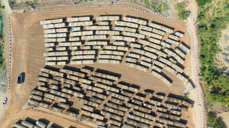 Drone shot aerial view of high angle view of a lot of sugarcane trucks queuing upの写真素材