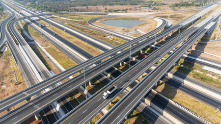 Drone shot aerial view of high angle view of intersection across the bridge against the countryside highwayの写真素材