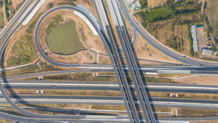 Drone shot aerial view of high angle view of intersection across the bridge against the countryside highwayの写真素材