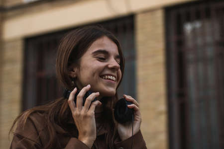 Girl listening to music in her headphones and enjoying