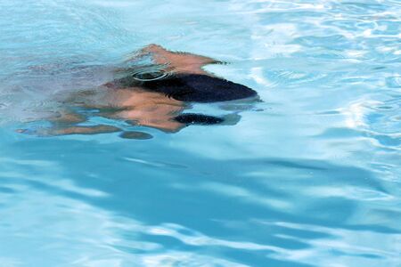 young girl swimming underwaterの写真素材