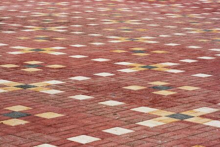 red and yellow patterned tiles usually found in on a playgroundの写真素材