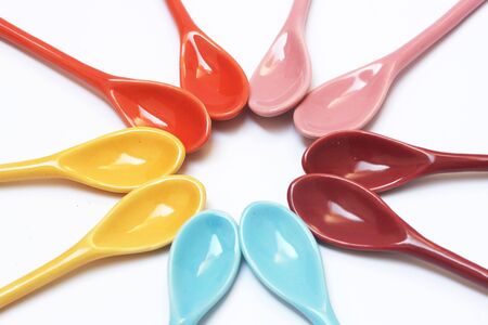 bright colored spoons isolated on a white background の写真素材