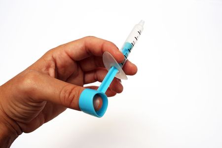 hand working a baby medical syringeの写真素材