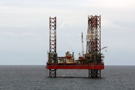 an oil rig at sea during the dayの写真素材