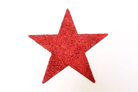 a red glitter star isolated on white backgroundの写真素材