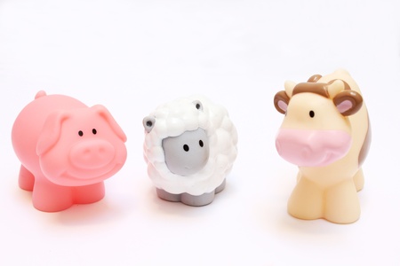 a pig a cow and a sheep toy isolated on whiteの写真素材