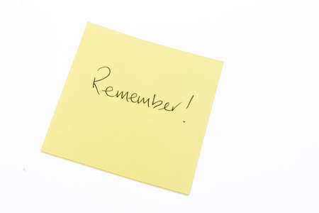 Remember written in black on a yellow post it noteの写真素材