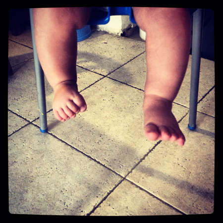 Baby in a high chair  feet view
