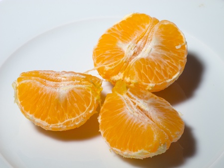 peeled tangerine in white dishの写真素材