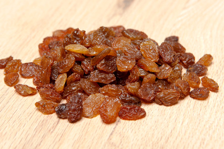 Raisins on wood plank, backgroundの写真素材