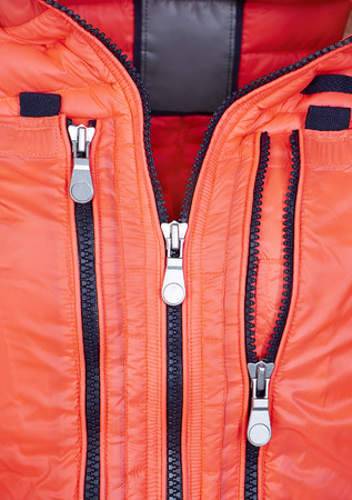 close up detail of orange jacket with zipper
