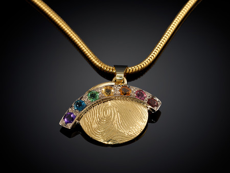 Golden necklace with gemstone isolated on black background.の写真素材