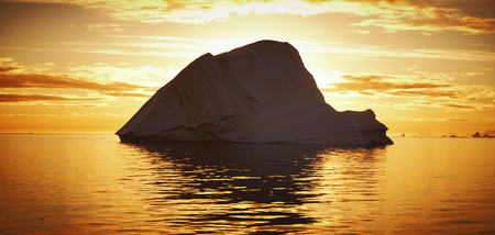 iceberg floating in greenland fjord.