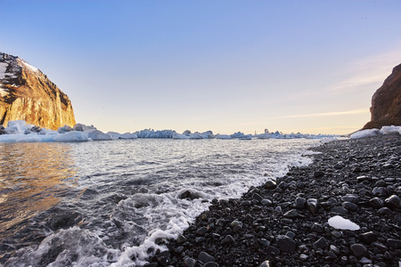 iceberg floating in greenland fjord.