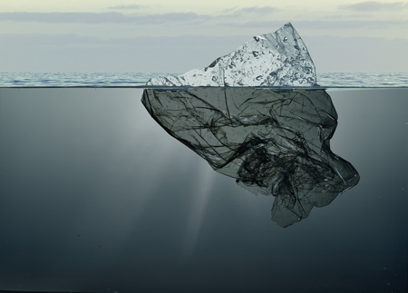 iceberg of garbage plastic floating in ocean with greenland background