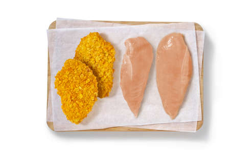 Raw chicken in a studio setting, on a cutting board.の写真素材