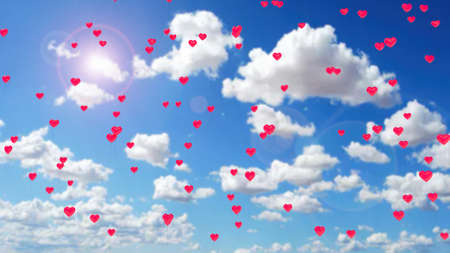 red heart balloons flying in the blue skyの写真素材
