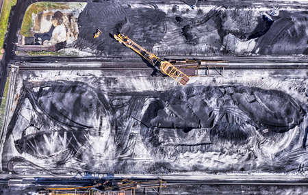 coal handling terminal and storage with heavy industry in the background.の写真素材
