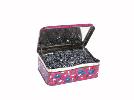 An old tin box full of Shoe nailsの写真素材