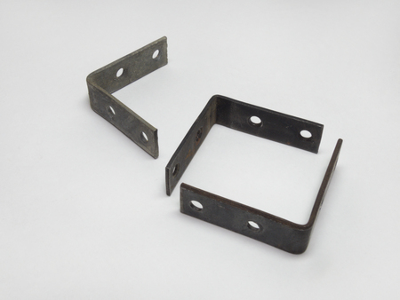 The metal mounting brackets with holes for screws. Closeupの写真素材