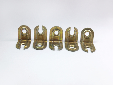Corners for furniture assembly. A metallic type of fastener. Laid out in a line. Gildedの写真素材