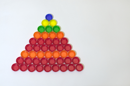 regular triangular pyramid of caps of plastic bottlesの写真素材