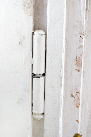 metal hinge of  old wooden windows, white paintedの写真素材