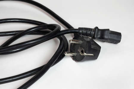 computer power cord, black, with europian plug, rolled in ring. closeupの写真素材