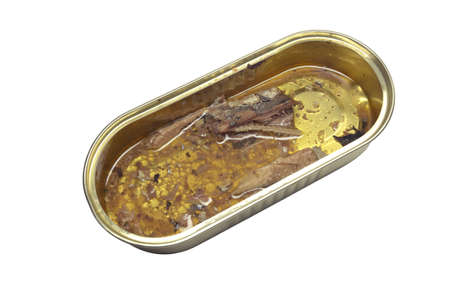 canned fish, sardines in oil. remains fish spine in an open tin can without lid. isolated on white...