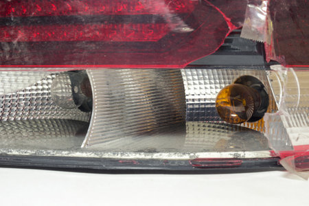tail light of sedan body car. broken plastic lens, close-up on light bulbsの写真素材