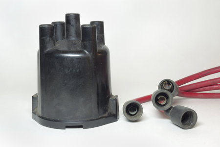 ignition distributor cap front side. set of high tension cables, rubber plug caps on terminalsの写真素材