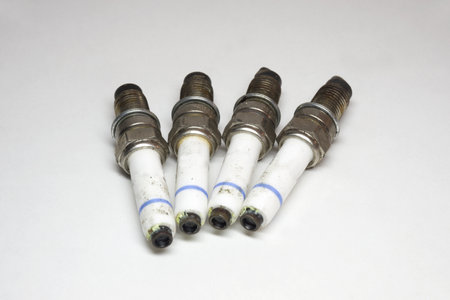 spark plugs kit, old and dirty plugs, white insulator with blue stripの写真素材
