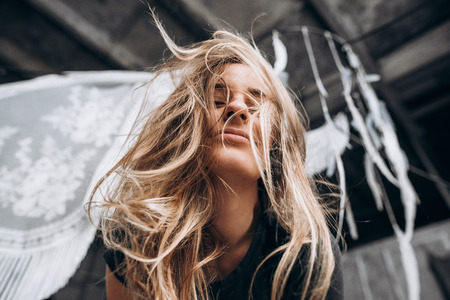 Cheerful girl with long blond hair. Bottom viewの写真素材